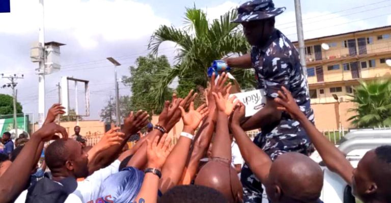 VIDEO: Na our money, protesters mock as Police share water, biscuits